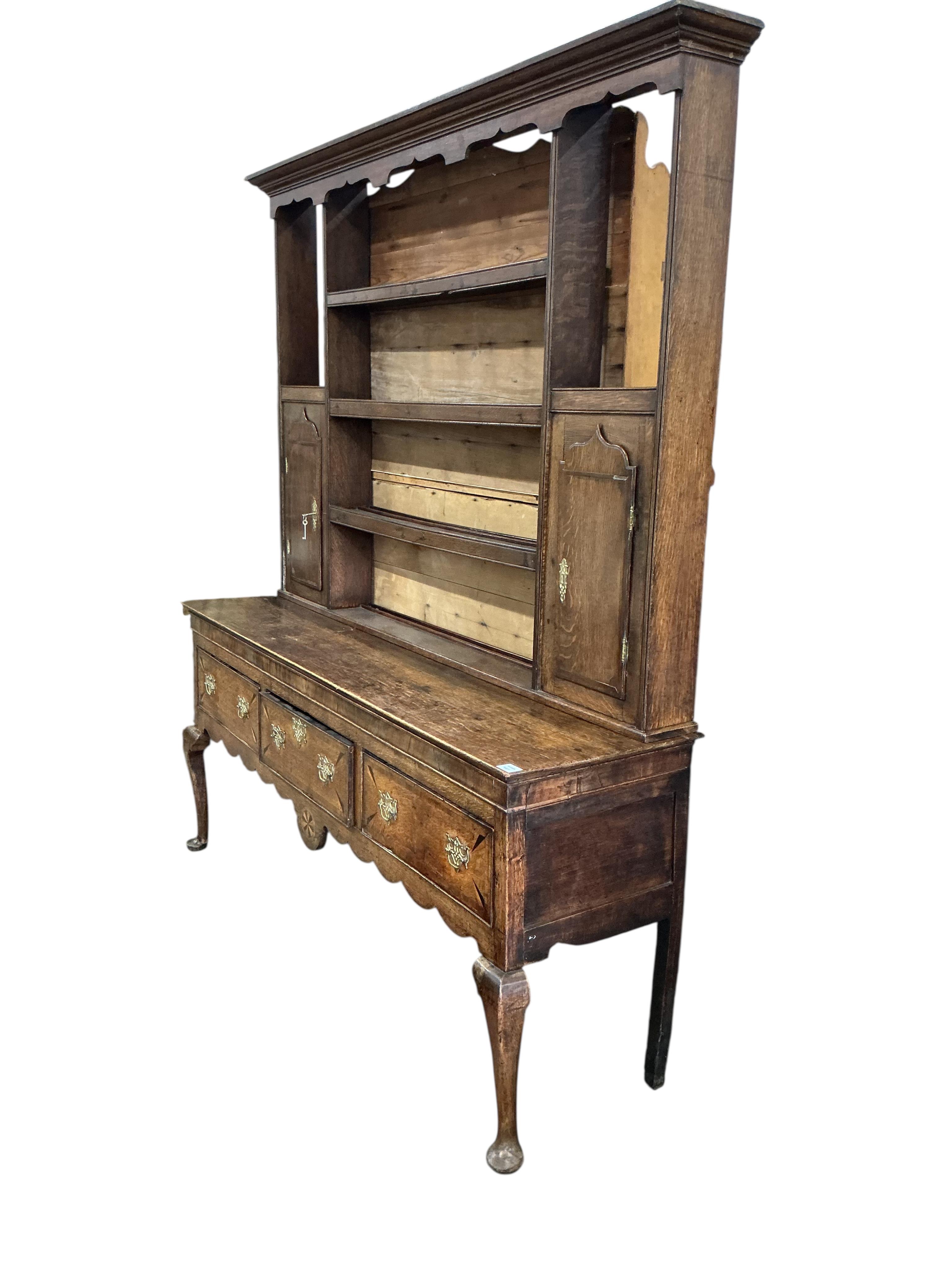 An 18th century inlaid oak dresser, width 183cm, depth 49cm, height 213cm